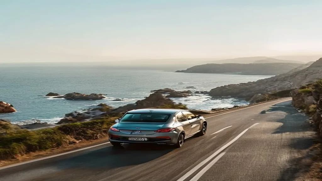 A car driving on a scenic Cyprus coastal road with the sea in the background