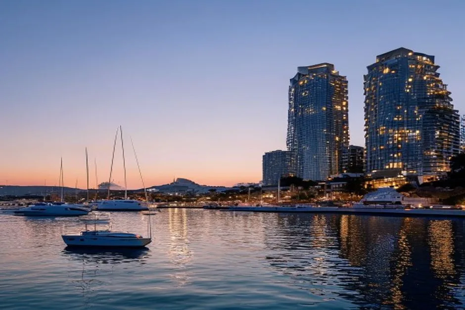 Limassol marina at dusk with yachts and modern apartment towers
